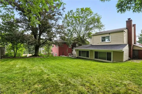 a view of a house with a backyard