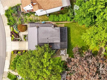 an aerial view of a house with a yard large tree and a outdoor space