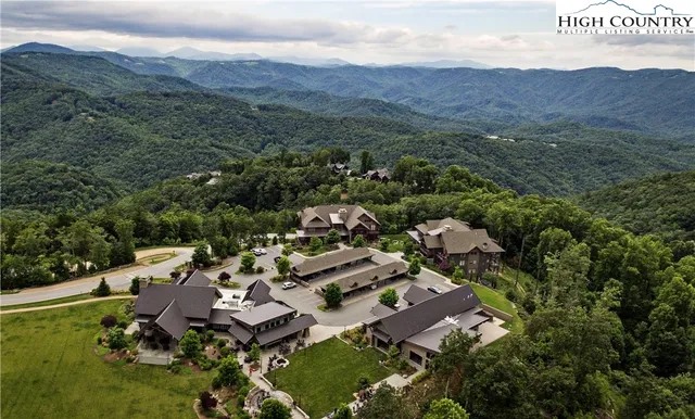 a view of a patio with table and chairs under an umbrella