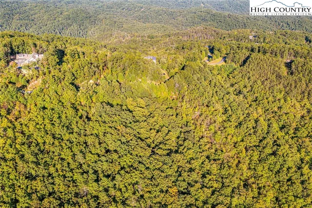 a view of a field with an ocean in the background