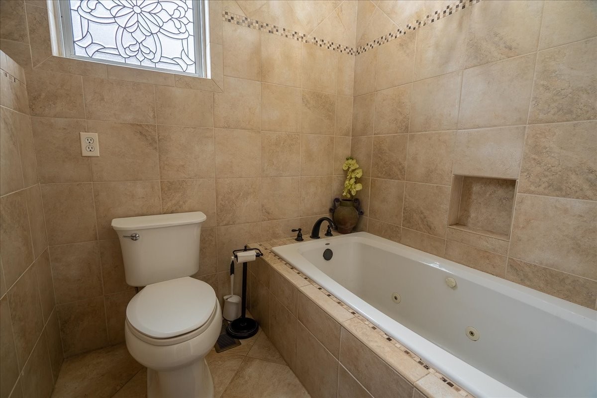 226 Nash Road Summertown, TN 38483 - Photo 19 of 55 a white toilet sitting next to a bath tub