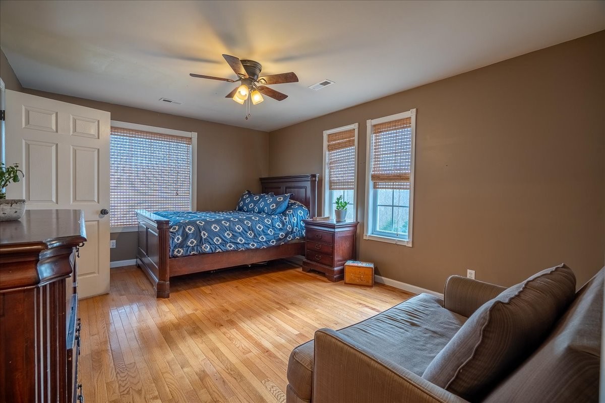 226 Nash Road Summertown, TN 38483 - Photo 27 of 55 a bedroom with a bed and a chandelier