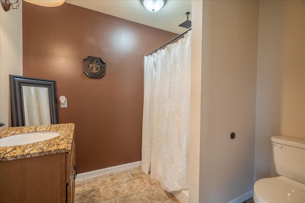 226 Nash Road Summertown, TN 38483 - Photo 30 of 55 a bathroom with a granite countertop sink and a toilet