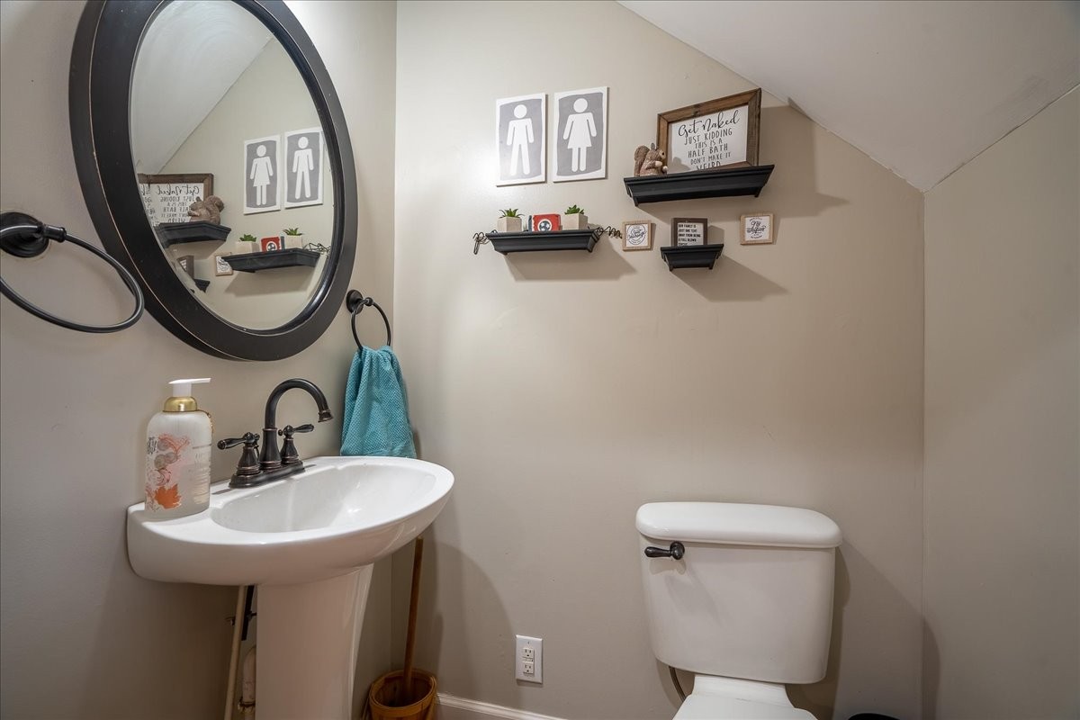 226 Nash Road Summertown, TN 38483 - Photo 37 of 55 a bathroom with a toilet a sink and a mirror