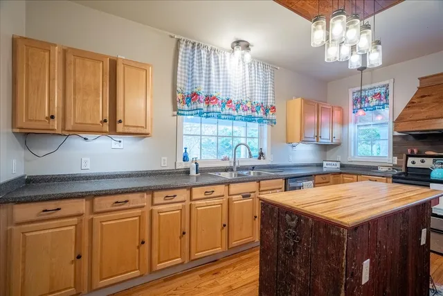a view of a dining room with furniture a chandelier and wooden floor