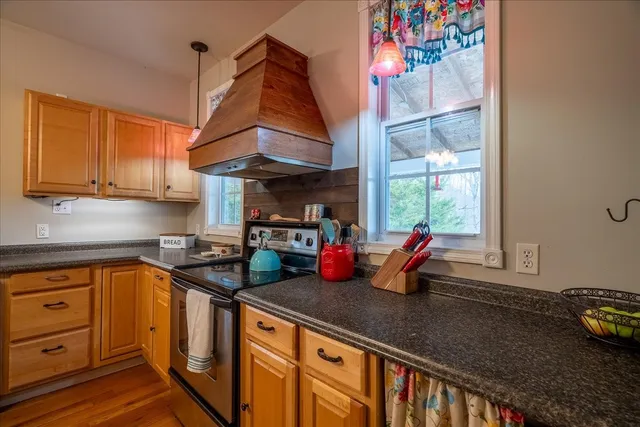 a view of a dining room with furniture and chandelier