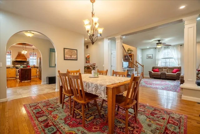 a view of a livingroom with furniture a dinning room and stairs