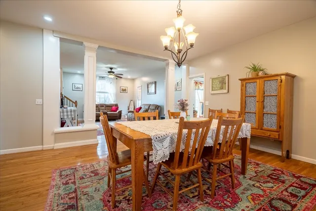 a bedroom with a large bed a flat tv screen and dresser