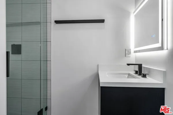 a bathroom with a sink and mirror