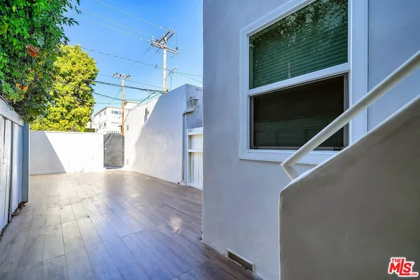 a view of entryway with a front door and wooden floor