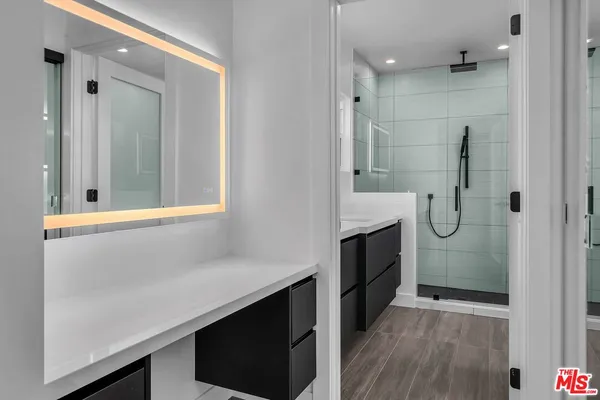 a bathroom with a shower and a sink