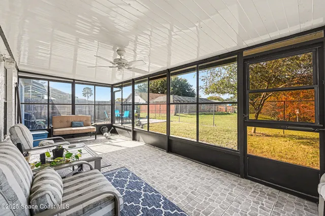 a spacious bedroom with a large window and a bed