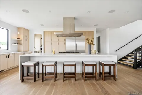 a kitchen with cabinets table and chairs