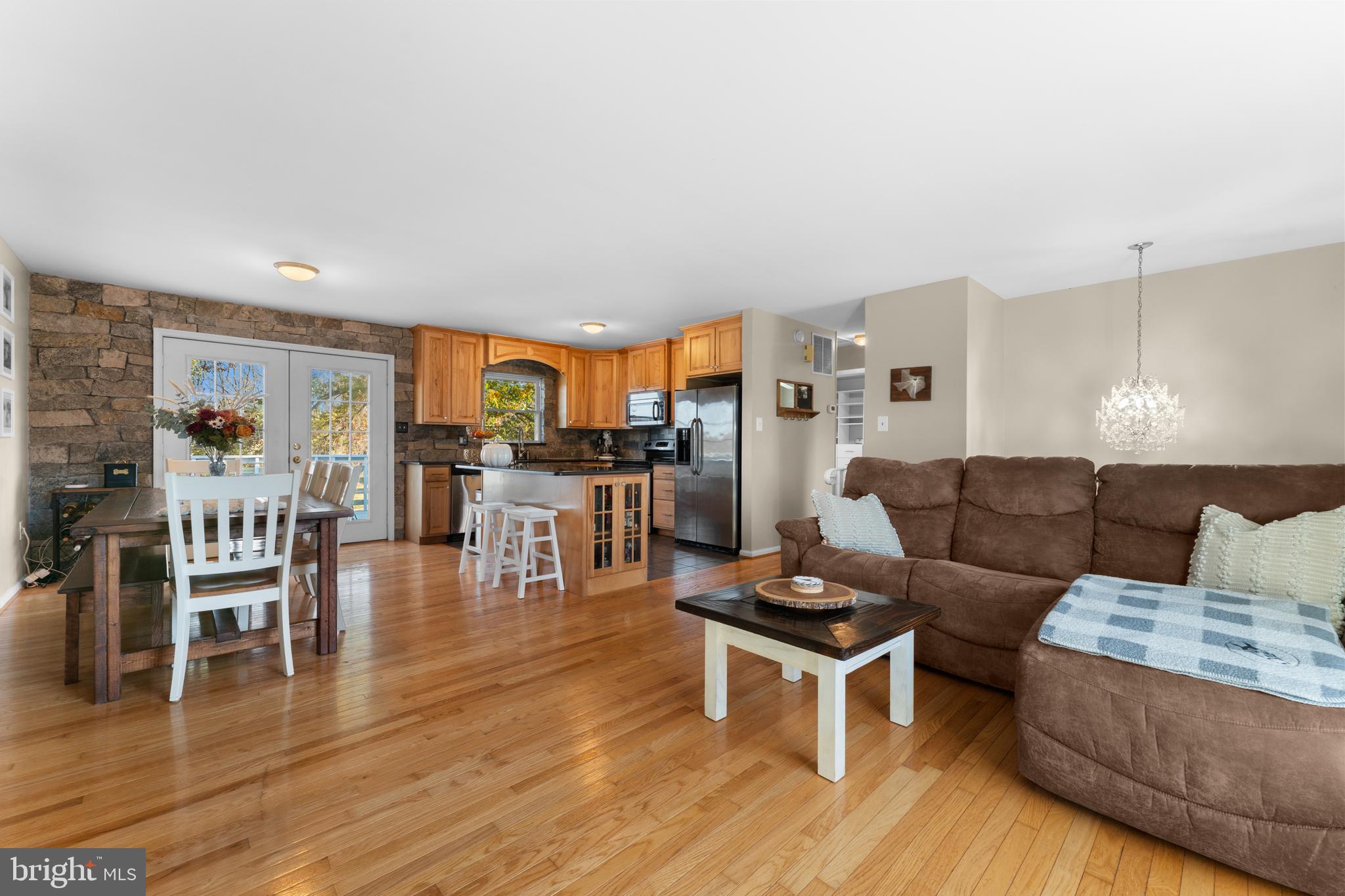 5057 Old Auburn Road Warrenton, VA 20187 - Photo 16 of 47 a living room with furniture wooden floor and kitchen view
