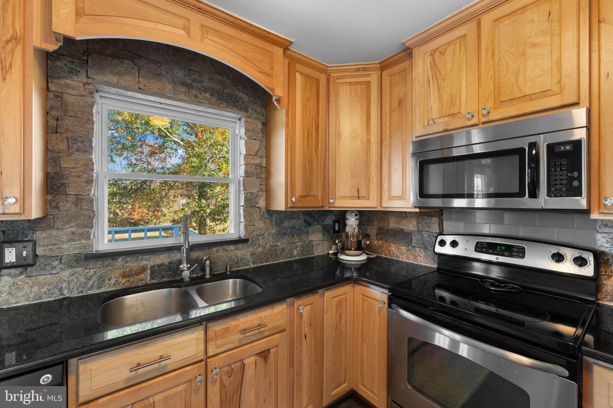 5057 Old Auburn Road Warrenton, VA 20187 - Photo 20 of 47 a kitchen with stainless steel appliances a sink a stove a microwave cabinets and a window