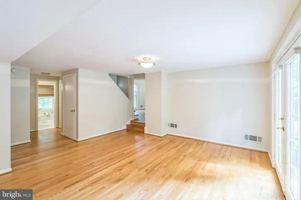 a view of an empty room and wooden floor