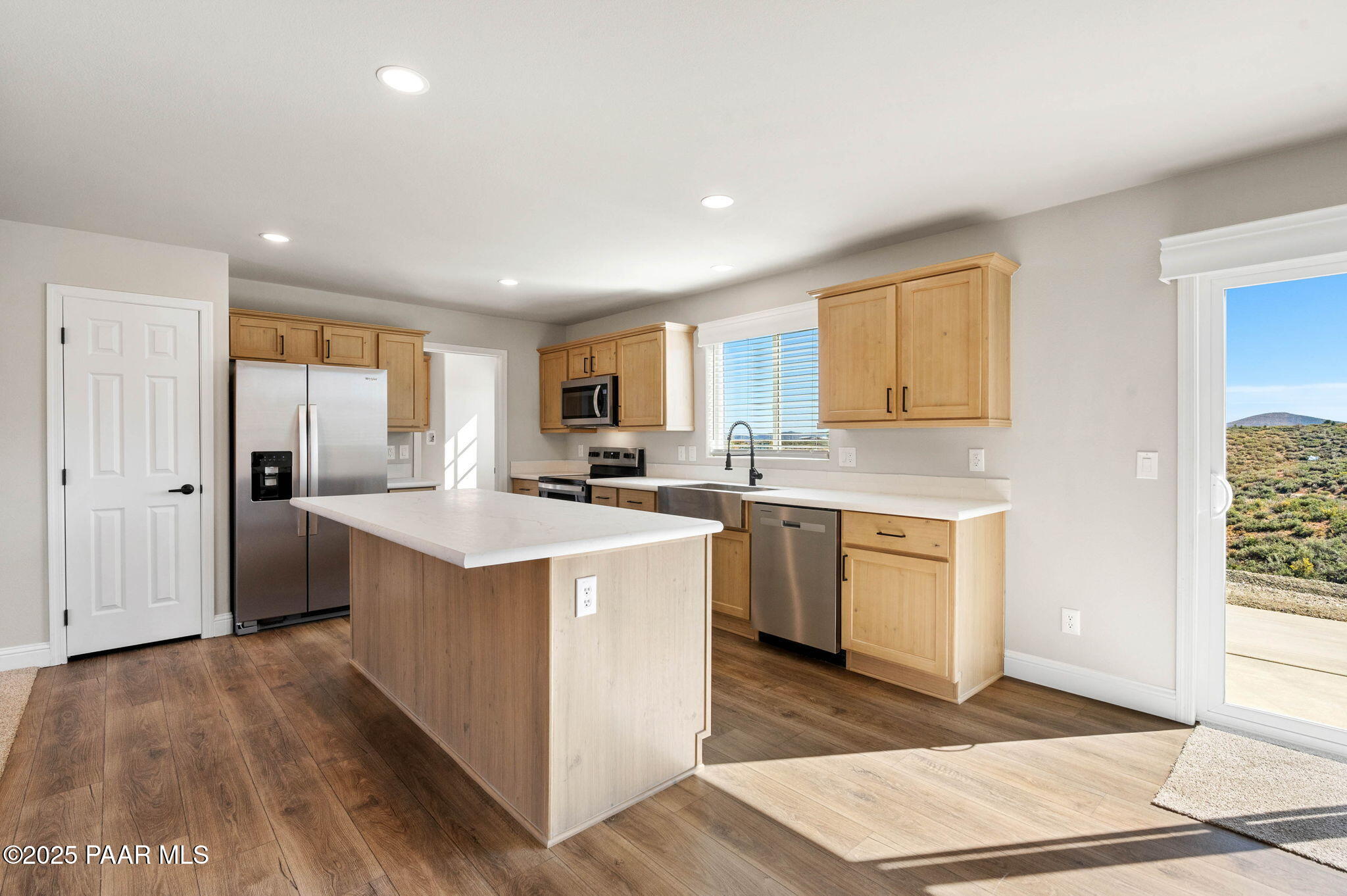 9815 East Ringold Road Dewey, AZ 86327 - Photo 15 of 25 a kitchen with stainless steel appliances granite countertop a stove a sink dishwasher a refrigerator and a oven with wooden floor