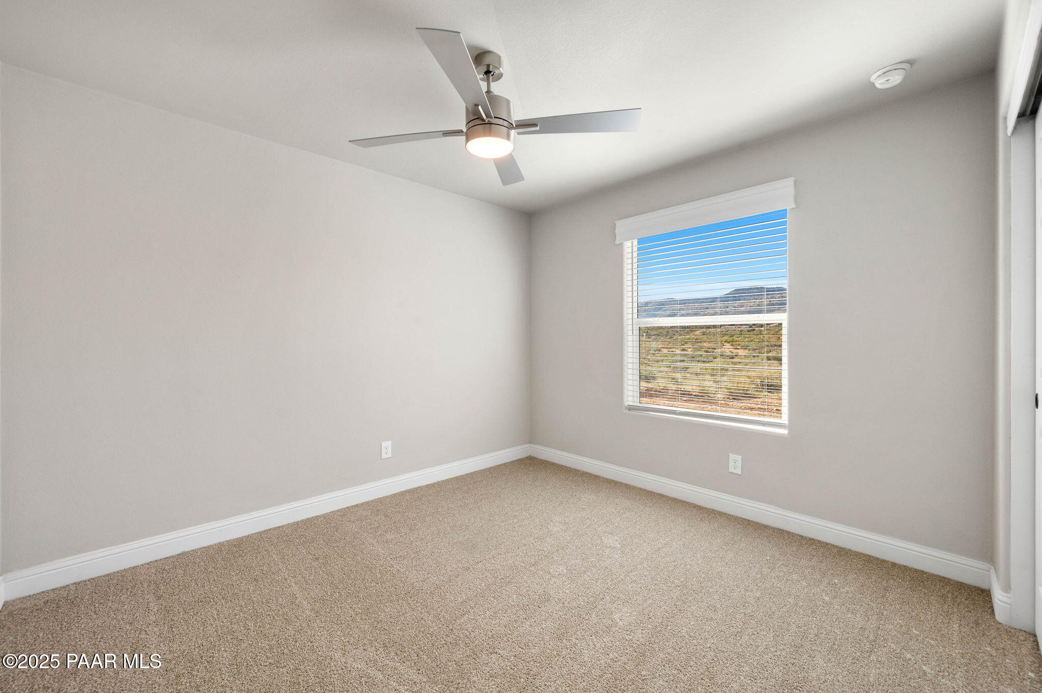 9815 East Ringold Road Dewey, AZ 86327 - Photo 16 of 25 an empty room with a window and a fan