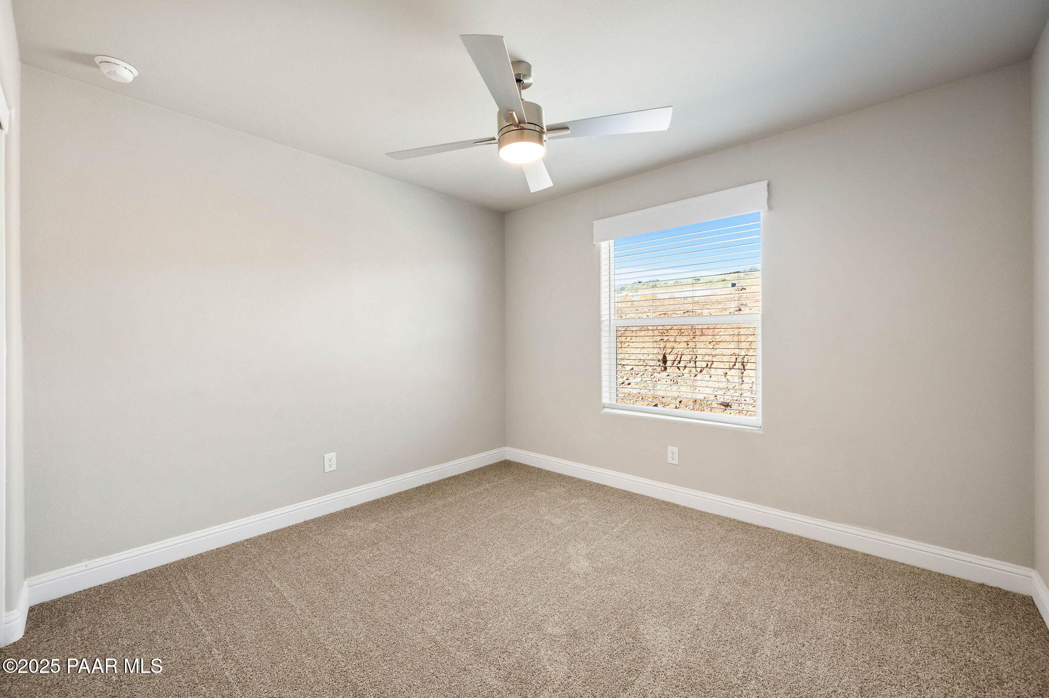 9815 East Ringold Road Dewey, AZ 86327 - Photo 18 of 25 an empty room with a window and a ceiling fan