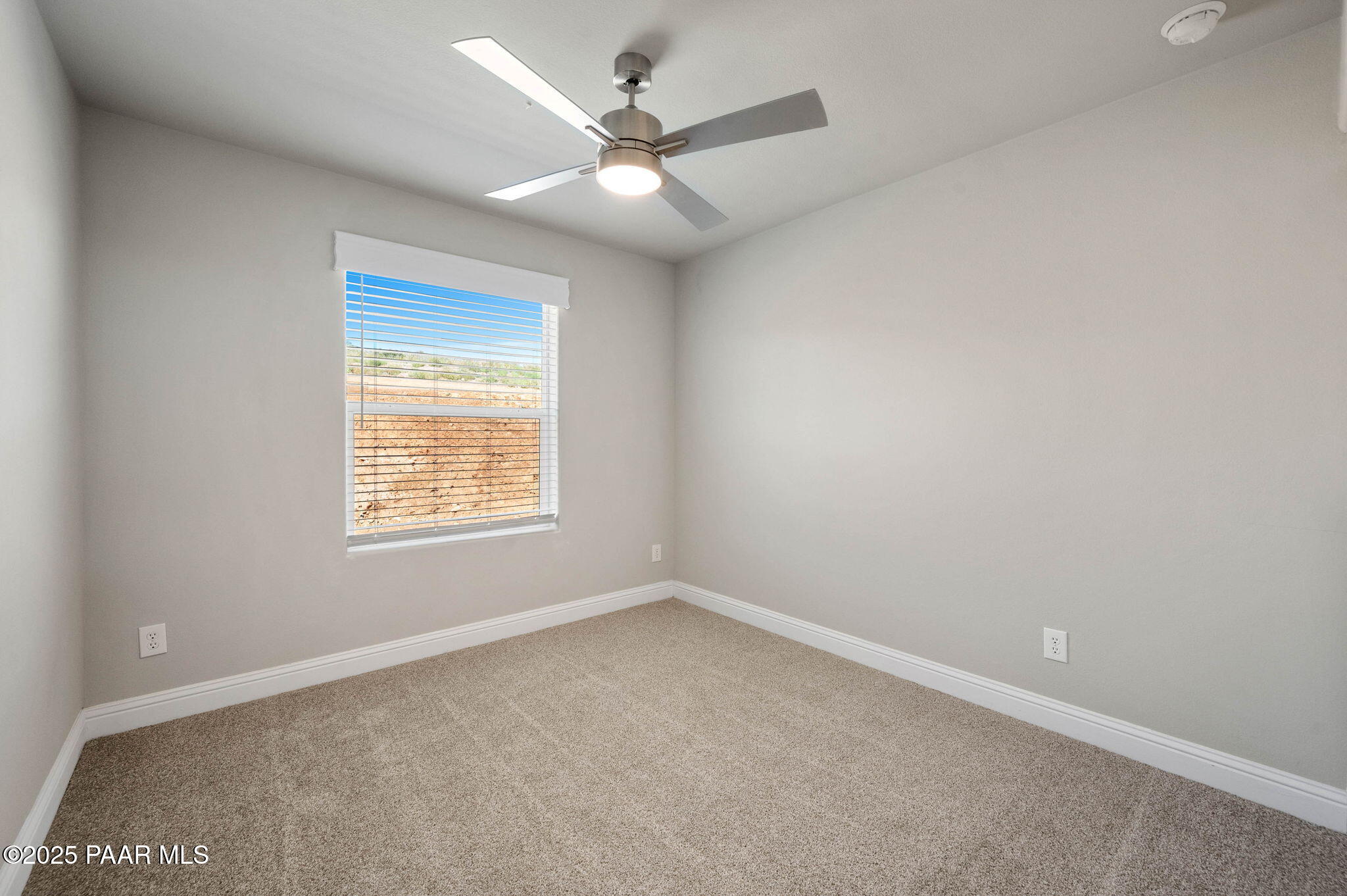 9815 East Ringold Road Dewey, AZ 86327 - Photo 19 of 25 an empty room with a window and a ceiling fan