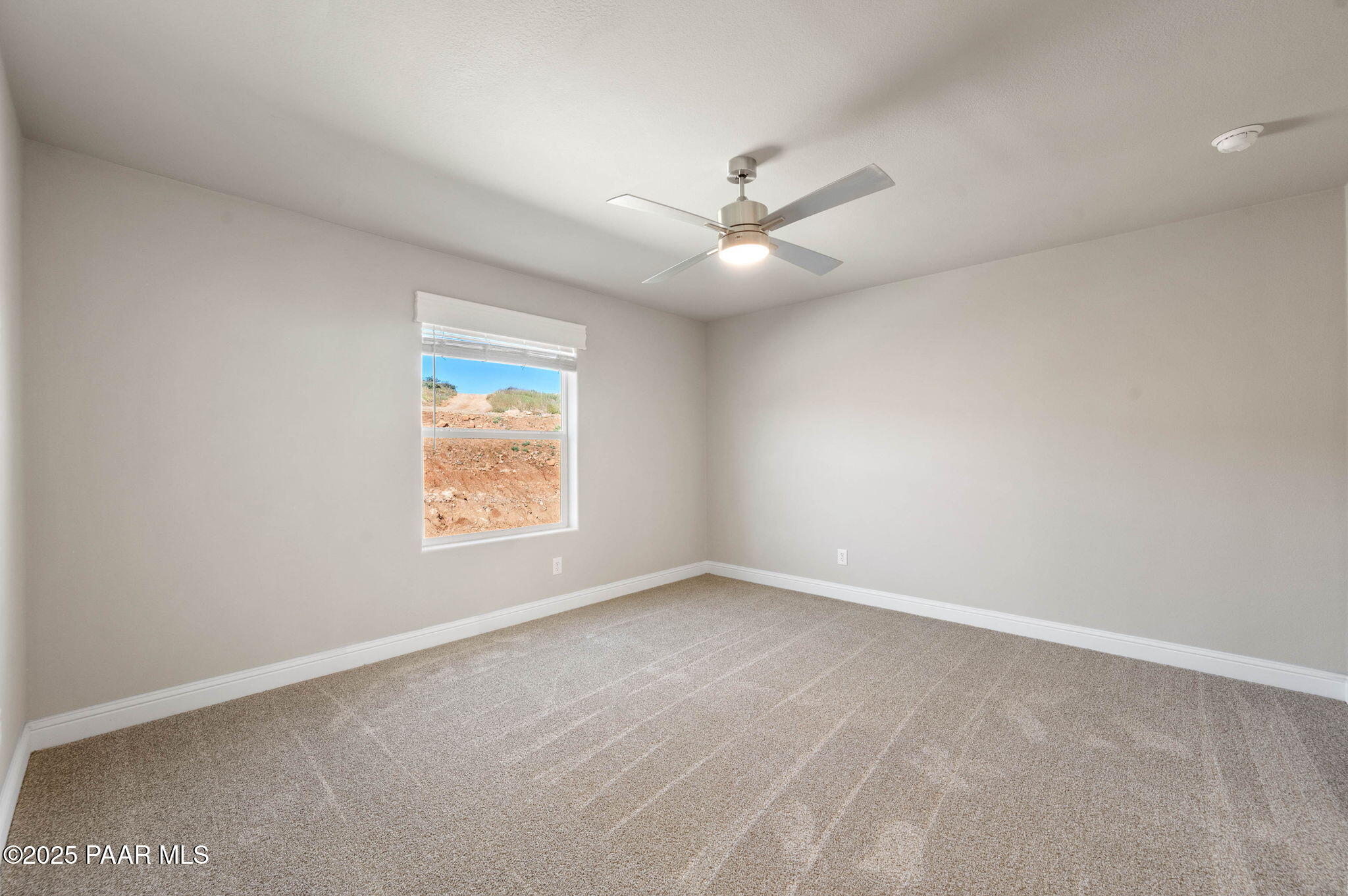 9815 East Ringold Road Dewey, AZ 86327 - Photo 20 of 25 an empty room with a window and a fan