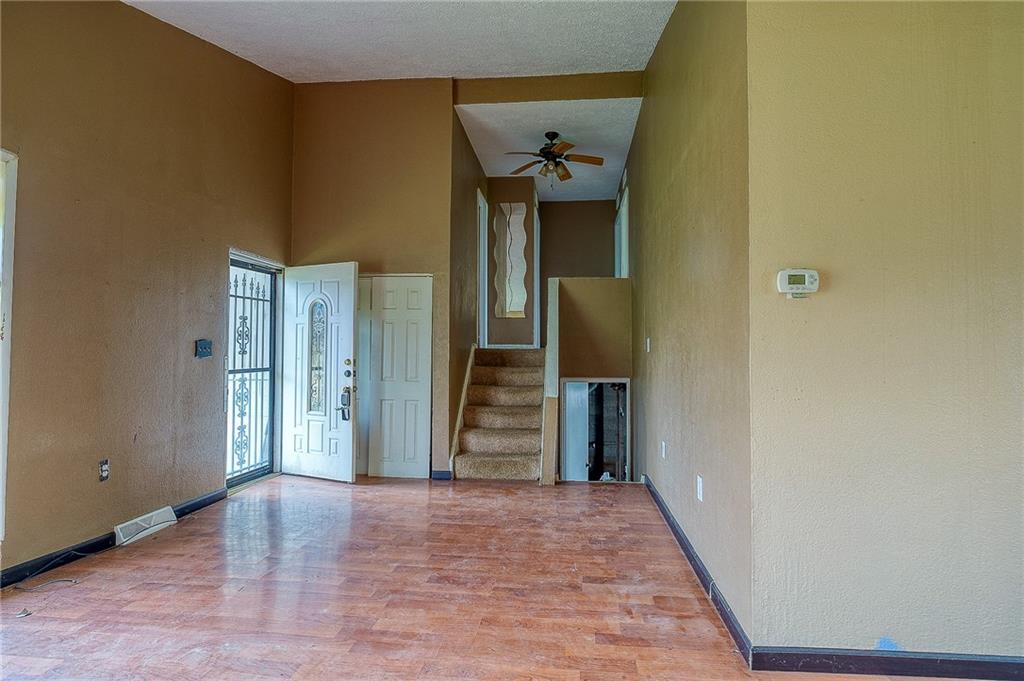 81 Ewing Road McKees Rocks, PA 15136 - Photo 3 of 14 a view of a hallway with wooden floor and staircase