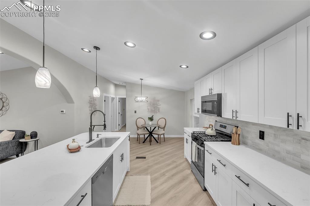 6185 Night Train Lane Yoder, CO 80864 - Photo 12 of 38 a kitchen with sink a counter space appliances and cabinets