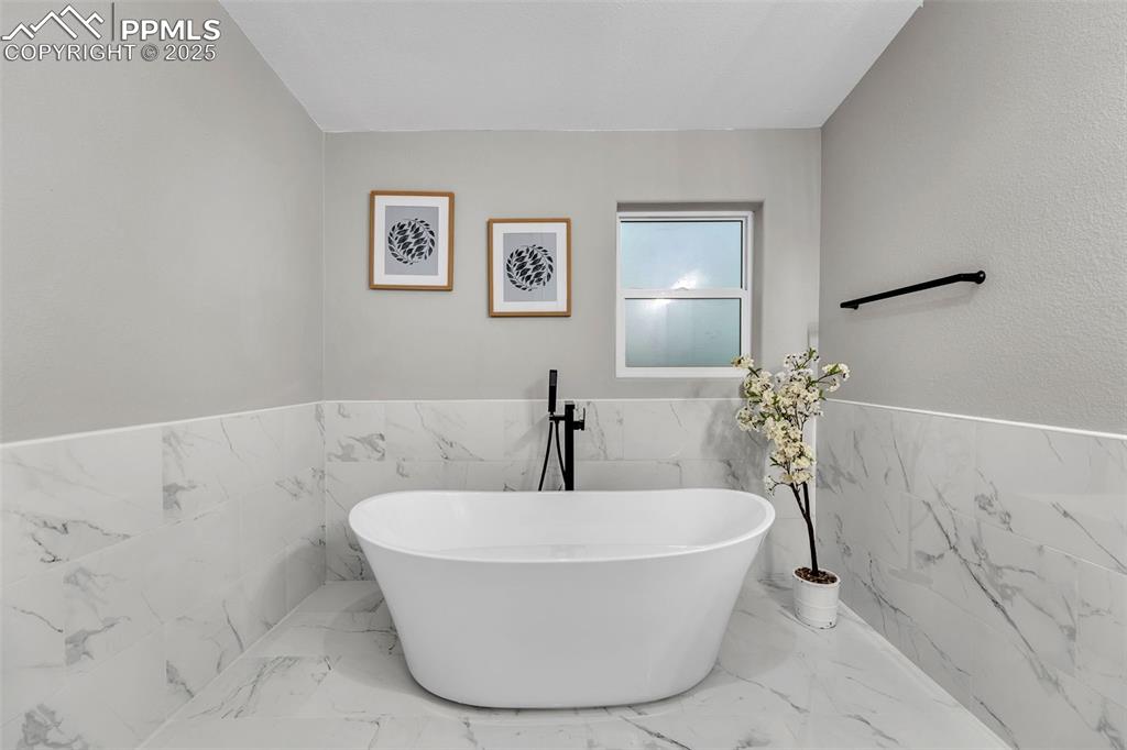 6185 Night Train Lane Yoder, CO 80864 - Photo 19 of 38 a white bath tub sitting in a bathroom