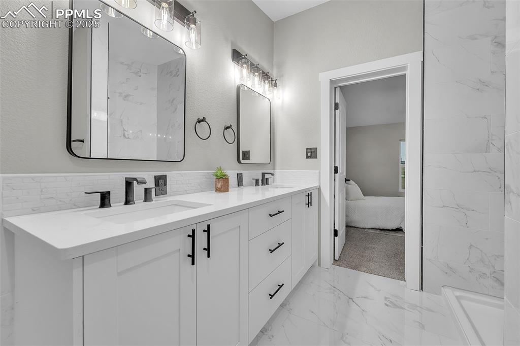 6185 Night Train Lane Yoder, CO 80864 - Photo 20 of 38 a bathroom with a sink a toilet and a mirror