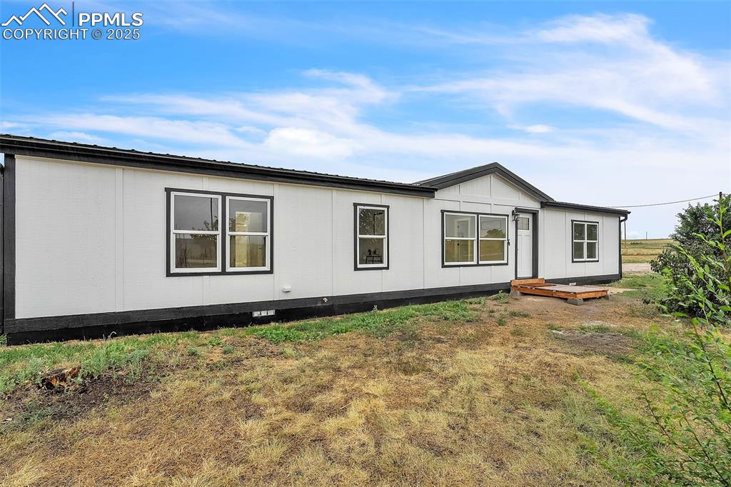 6185 Night Train Lane Yoder, CO 80864 - Photo 2 of 38 a house with trees in front of it