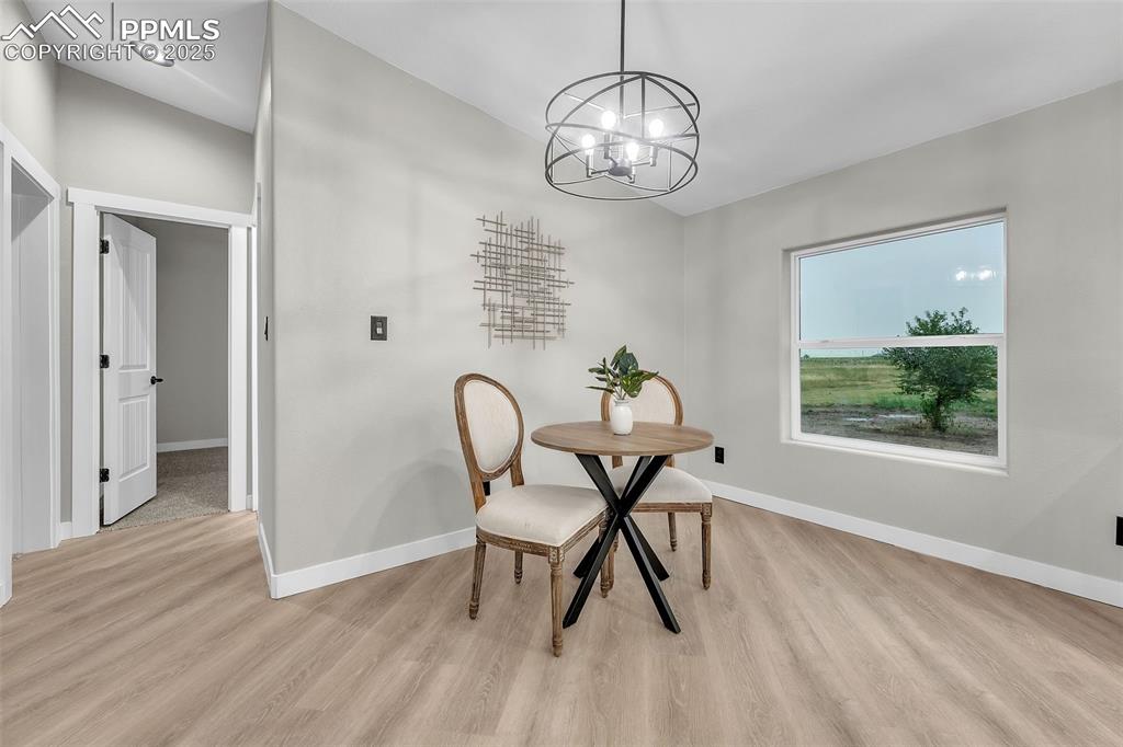 6185 Night Train Lane Yoder, CO 80864 - Photo 23 of 38 a view of a dining room with furniture window and wooden floor