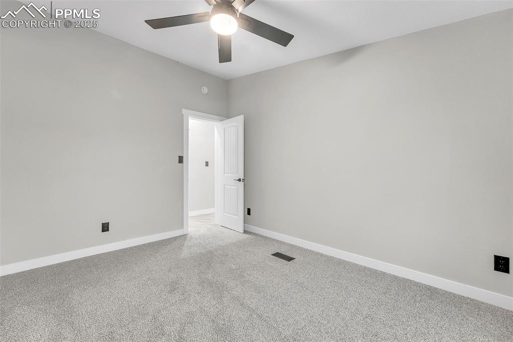 6185 Night Train Lane Yoder, CO 80864 - Photo 29 of 38 an empty room with chandelier fan