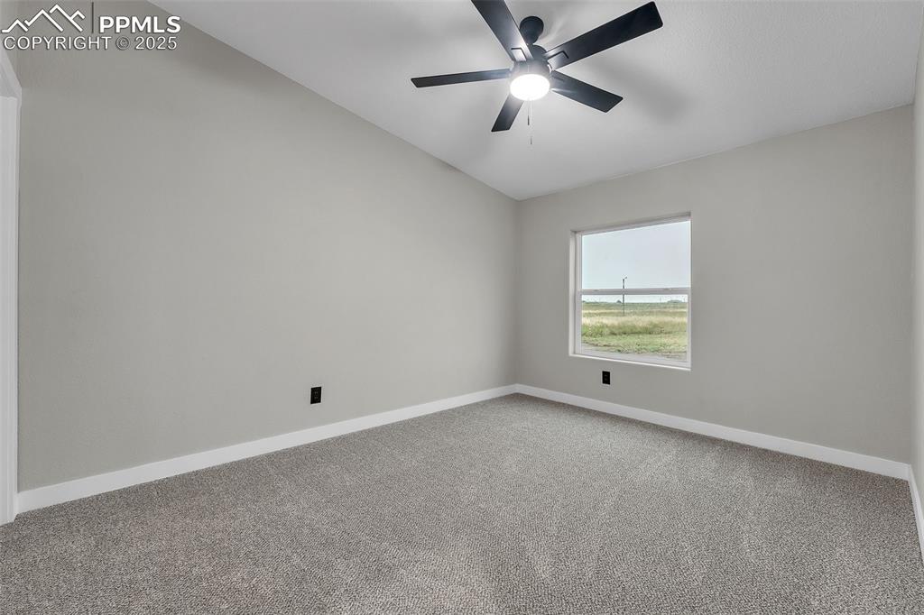 6185 Night Train Lane Yoder, CO 80864 - Photo 30 of 38 an empty room with a window and ceiling fan