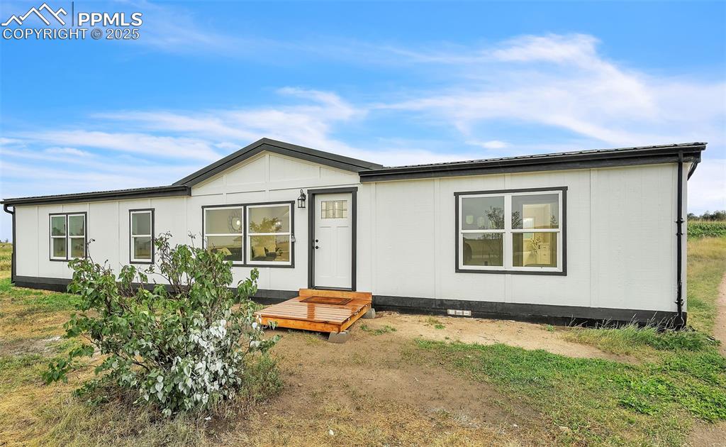6185 Night Train Lane Yoder, CO 80864 - Photo 3 of 38 a backyard of a house with table and chairs
