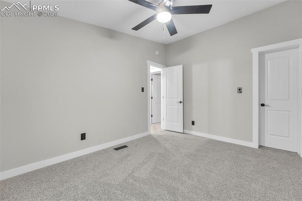 6185 Night Train Lane Yoder, CO 80864 - Photo 31 of 38 an empty room with a ceiling fan and a window