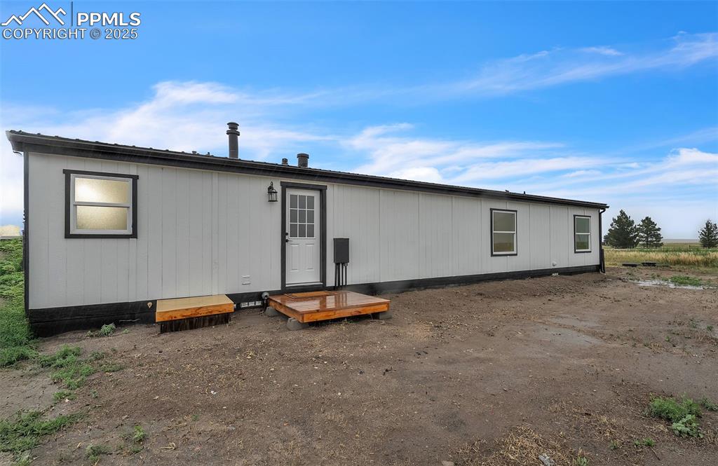 6185 Night Train Lane Yoder, CO 80864 - Photo 35 of 38 a view of a backyard with a table and chair