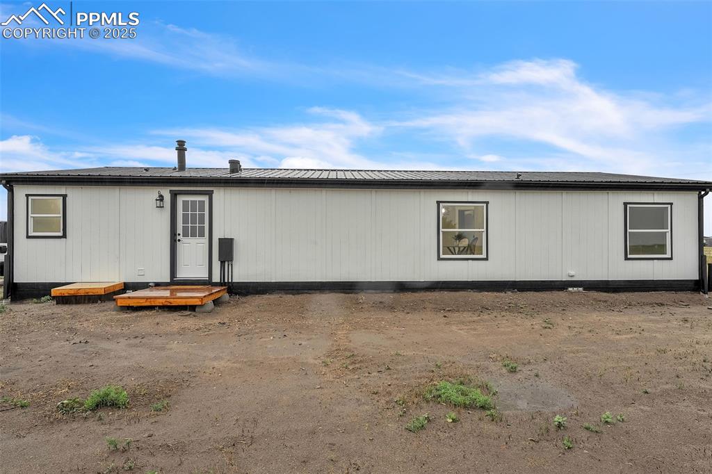 6185 Night Train Lane Yoder, CO 80864 - Photo 36 of 38 a backyard of a house with lawn chairs