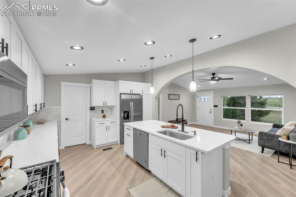 6185 Night Train Lane Yoder, CO 80864 - Photo 8 of 38 a spacious bathroom with a double vanity sink a mirror a bathtub and a shower