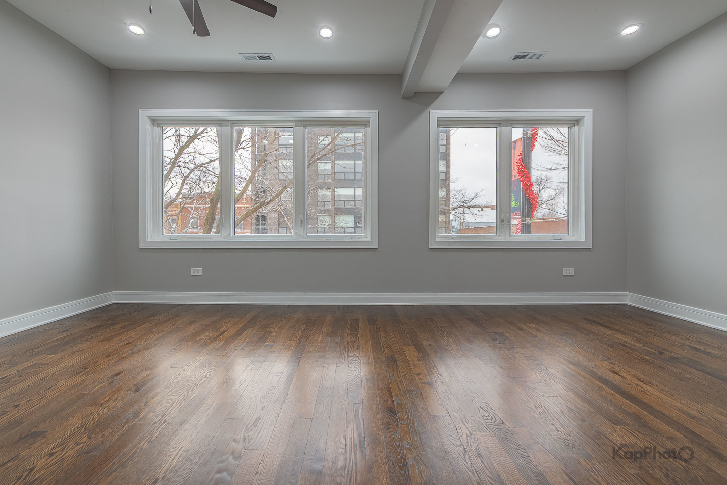 3044 West Irving Park Road Chicago, IL 60618 - Photo 13 of 37 an empty room with wooden floor and windows