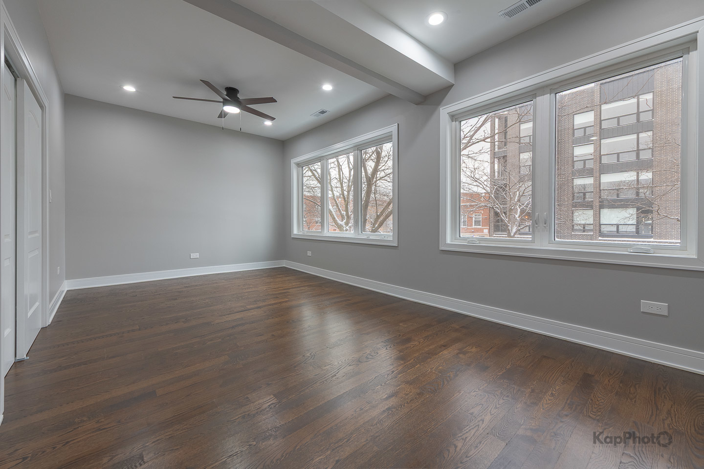 3044 West Irving Park Road Chicago, IL 60618 - Photo 15 of 37 an empty room with wooden floor and windows