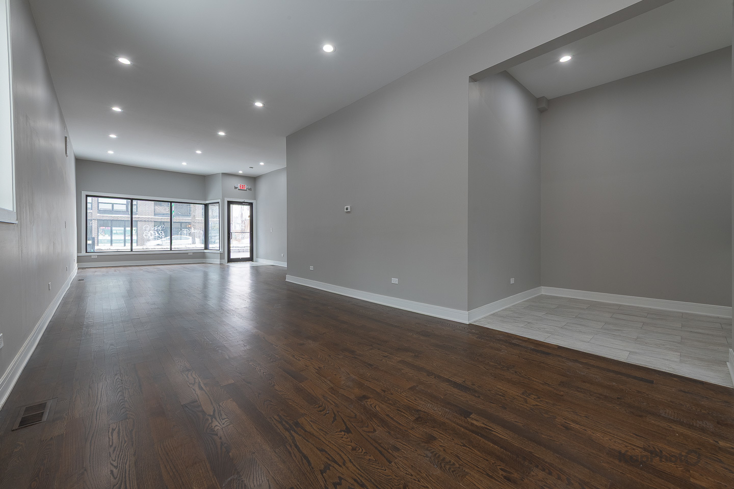3044 West Irving Park Road Chicago, IL 60618 - Photo 2 of 37 a view of an empty room with wooden floor and a window