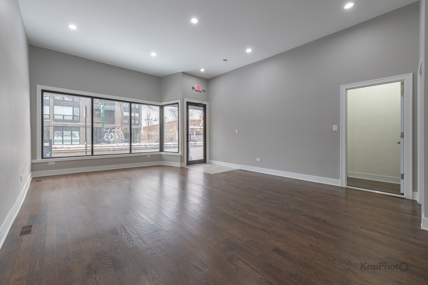3044 West Irving Park Road Chicago, IL 60618 - Photo 3 of 37 a view of an empty room with wooden floor and a window