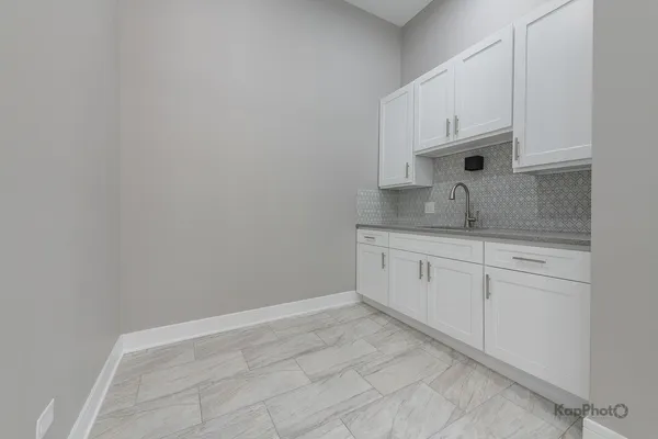 a view of cabinets a sink and dishwasher in a white cabinet