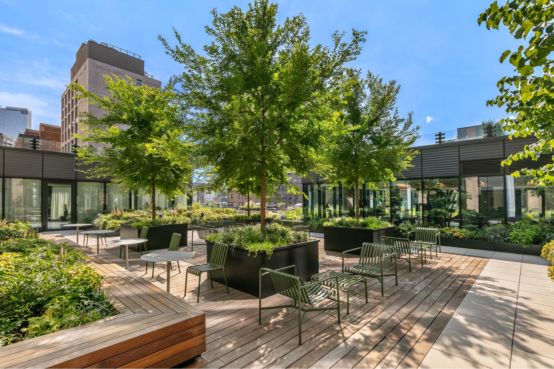 202 Broome Street, Unit 6F Manhattan, NY 10002 - Photo 15 of 19 a view of a patio with table and chairs potted plants and large tree