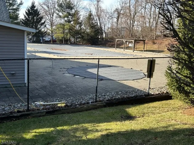 a view of a swimming pool with a yard