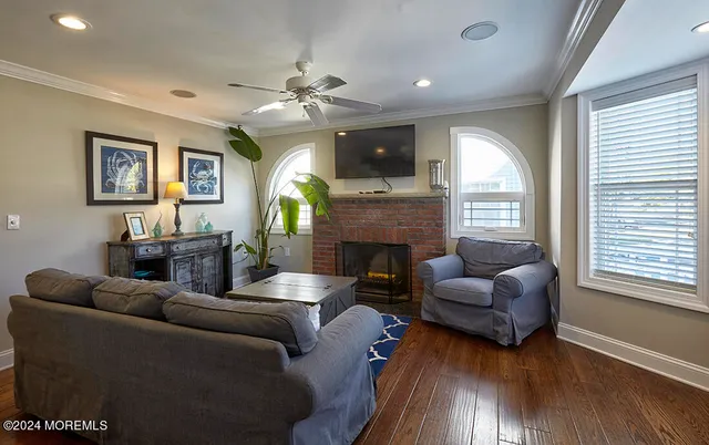 a living room with furniture a fireplace and a flat screen tv