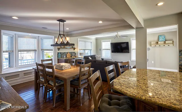 a dining table with chairs and window