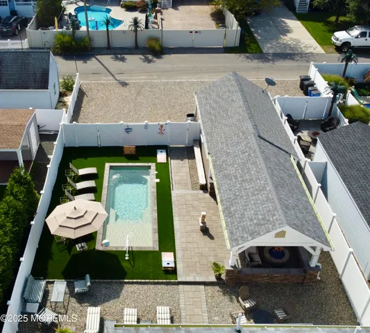 a aerial view of a house with a yard and furniture