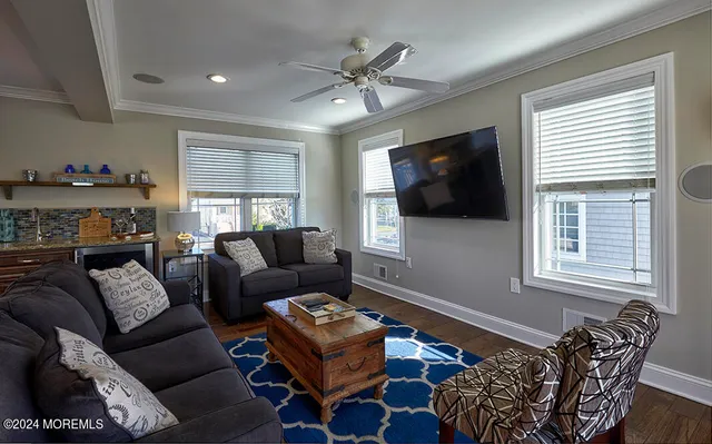 a living room with furniture a large window and a rug
