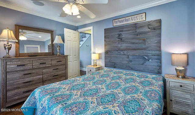 a bedroom with a bed and a lamp on dresser